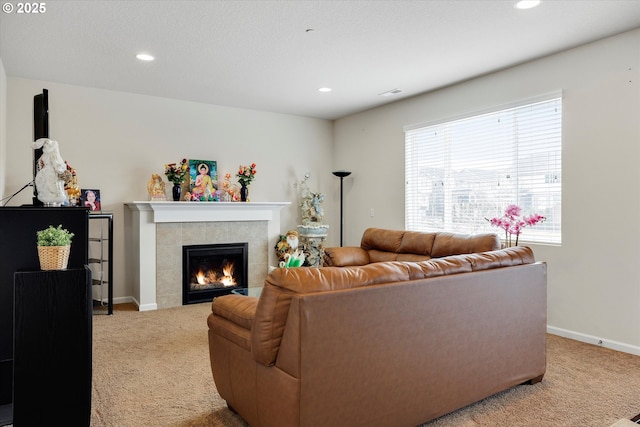 carpeted living room featuring a fireplace