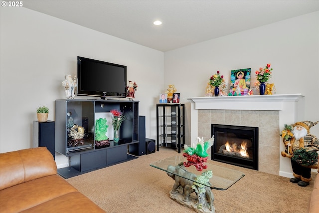 carpeted living room with a tiled fireplace