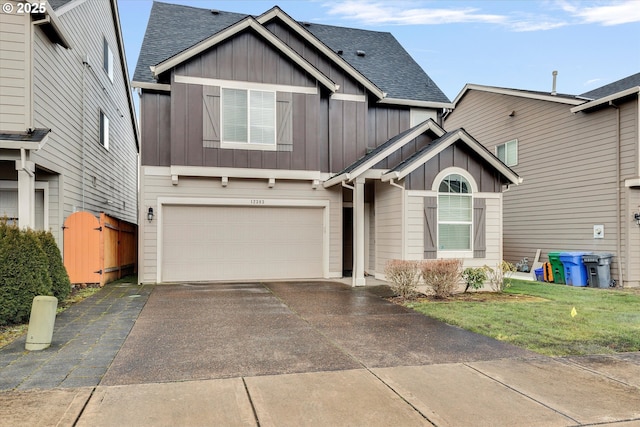 craftsman-style home featuring a garage and a front yard