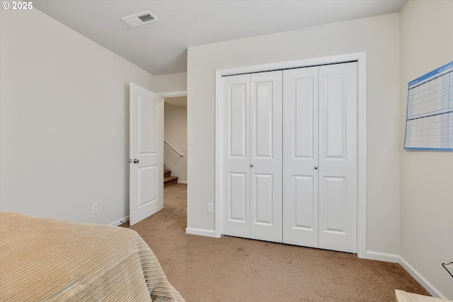 bedroom with a closet and light carpet