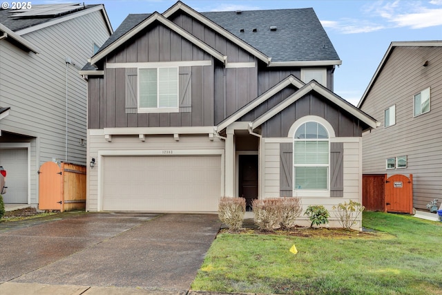 craftsman-style house featuring a garage and a front lawn