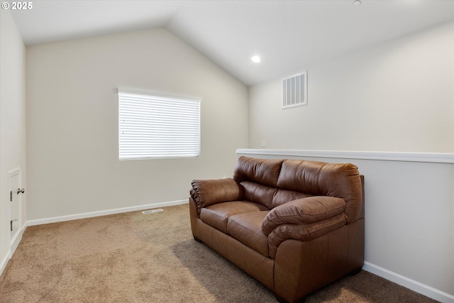 living area featuring lofted ceiling and carpet flooring