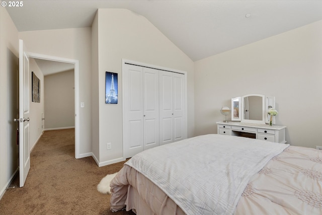 bedroom featuring lofted ceiling, light carpet, and a closet