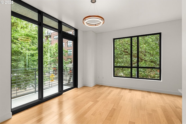 922 NW 11th Ave Unit 209, Portland, OR 97209 - empty room with plenty of natural light and wood finished floors