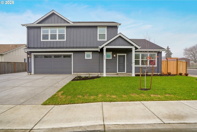 view of front facade with driveway, a front lawn, an attached garage, and fence