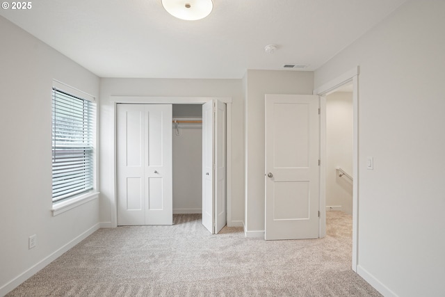 unfurnished bedroom featuring carpet floors, visible vents, and baseboards