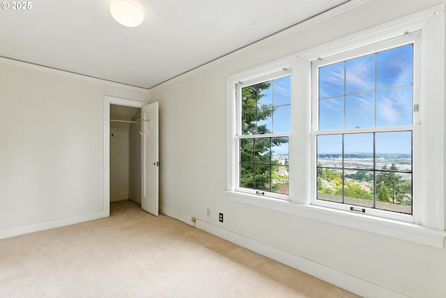 368 NW Lomita Ter, Portland, OR 97210 - unfurnished bedroom featuring light colored carpet, ornamental molding, and a closet