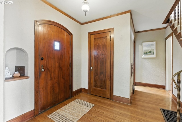 368 NW Lomita Ter, Portland, OR 97210 - entryway with light wood-style flooring, ornamental molding, and arched walkways