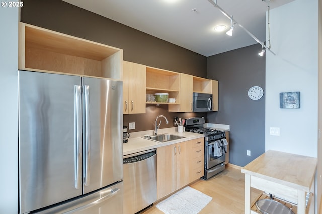 1255 NW 9th Ave Unit 508, Portland, OR 97209 - kitchen with stainless steel appliances, light brown cabinets, a sink, open shelves, and light wood-type flooring
