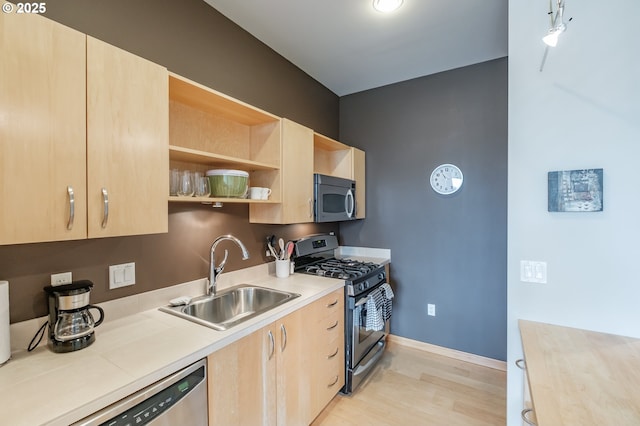 1255 NW 9th Ave Unit 508, Portland, OR 97209 - kitchen featuring stainless steel appliances, light brown cabinets, a sink, light wood-style flooring, and light countertops