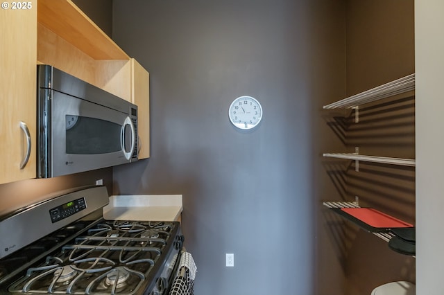 1255 NW 9th Ave Unit 508, Portland, OR 97209 - kitchen featuring appliances with stainless steel finishes and light brown cabinetry