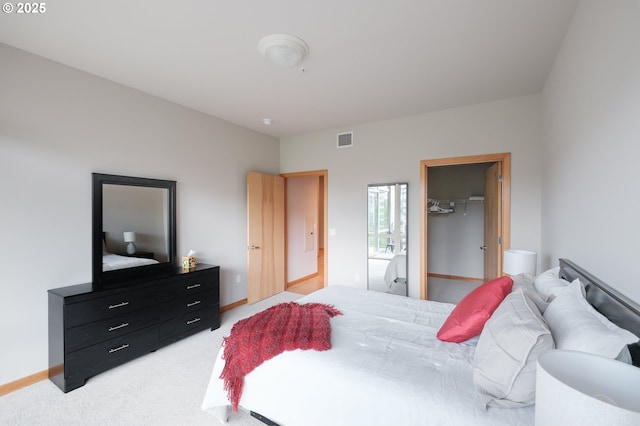 1255 NW 9th Ave Unit 508, Portland, OR 97209 - bedroom featuring light carpet, a spacious closet, a closet, and baseboards
