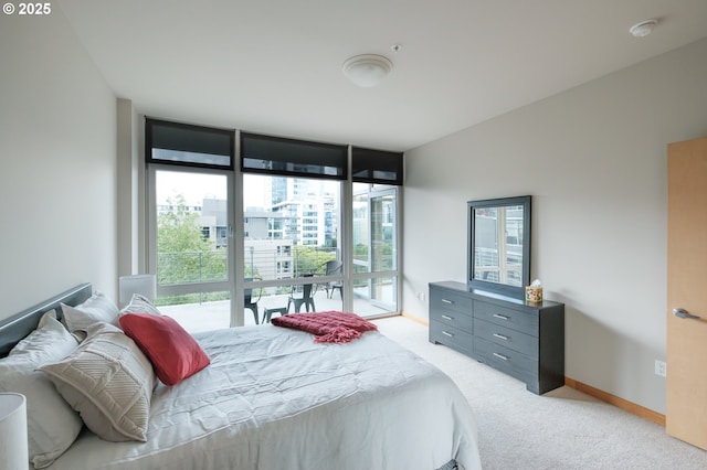 1255 NW 9th Ave Unit 508, Portland, OR 97209 - bedroom with light colored carpet, access to outside, and a wall of windows