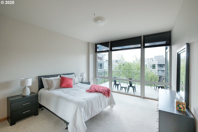1255 NW 9th Ave Unit 508, Portland, OR 97209 - bedroom with expansive windows, multiple windows, light colored carpet, and access to outside