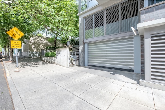 1255 NW 9th Ave Unit 508, Portland, OR 97209 - view of patio with a garage and concrete driveway