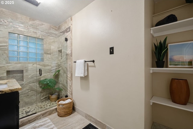 5005 NE Flanders St, Portland, OR 97213 - bathroom with a shower stall, vanity, and a textured ceiling