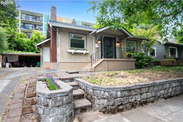 5005 NE Flanders St, Portland, OR 97213 - bungalow-style home with stucco siding and a chimney