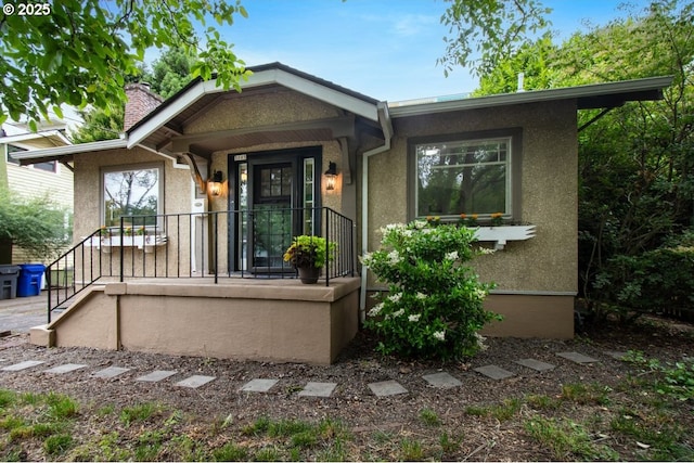 5005 NE Flanders St, Portland, OR 97213 - view of front facade with a chimney and stucco siding