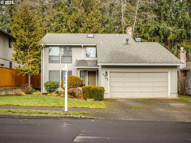 view of front of home with a garage and a front yard