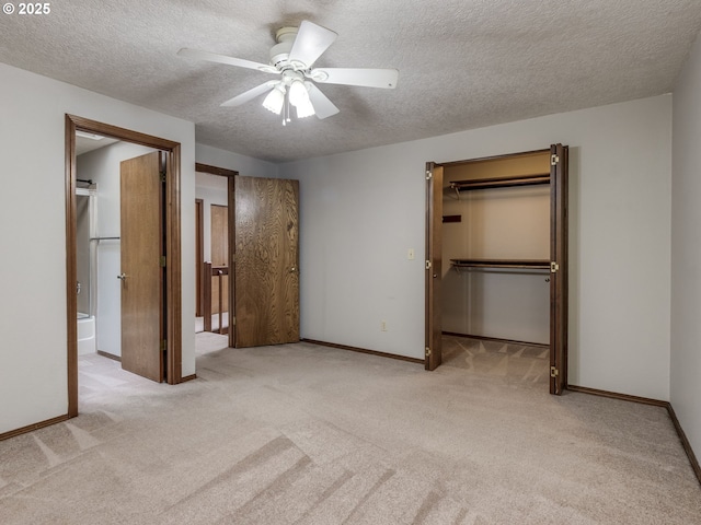 unfurnished bedroom featuring a spacious closet, light colored carpet, ceiling fan, a textured ceiling, and a closet