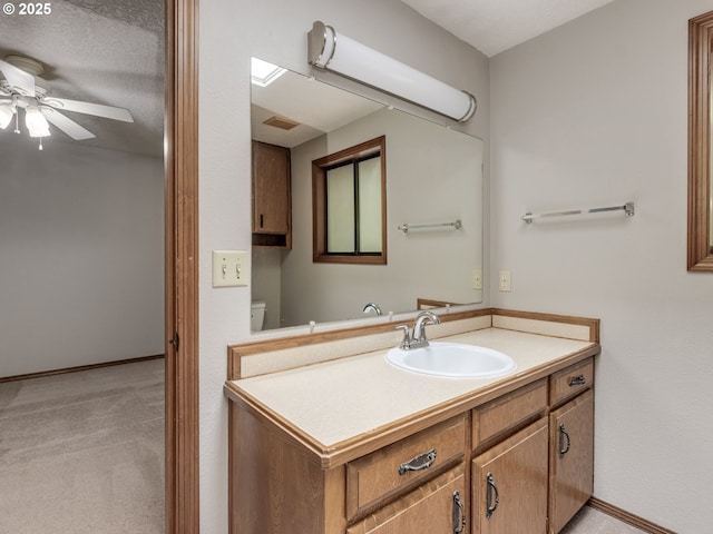 bathroom featuring vanity, ceiling fan, and toilet