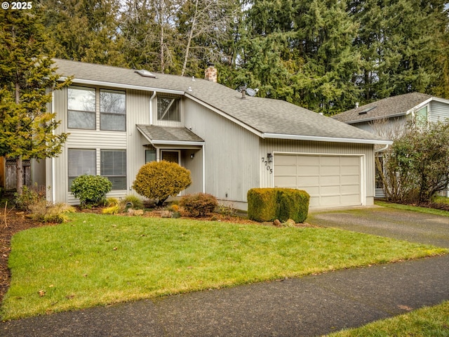 view of front of house with a garage and a front yard