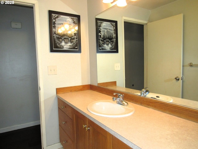 bathroom with baseboards and vanity