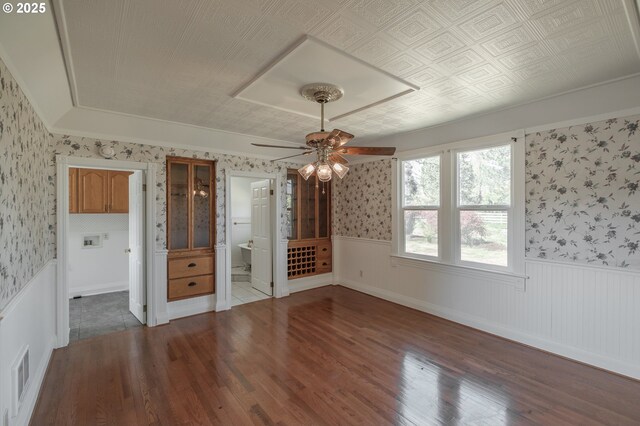 38588 Goar Rd, Scio, OR 97374 - unfurnished bedroom with wallpapered walls, wainscoting, wood finished floors, connected bathroom, and ceiling fan
