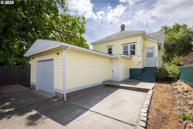 215 W 9th St, The Dalles, OR 97058 - back of house featuring a chimney and concrete driveway