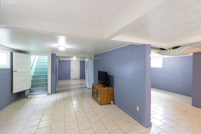 215 W 9th St, The Dalles, OR 97058 - below grade area featuring a textured ceiling, stairway, and light tile patterned floors