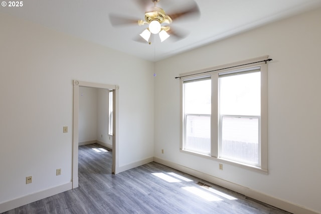 215 W 9th St, The Dalles, OR 97058 - empty room with healthy amount of natural light, a ceiling fan, and wood finished floors