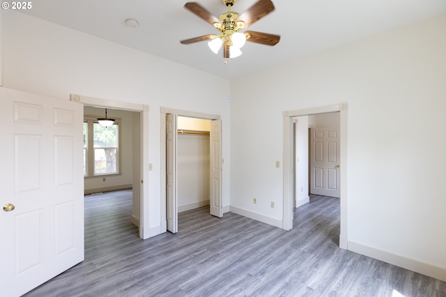 215 W 9th St, The Dalles, OR 97058 - unfurnished bedroom with light wood-type flooring, a closet, and a ceiling fan