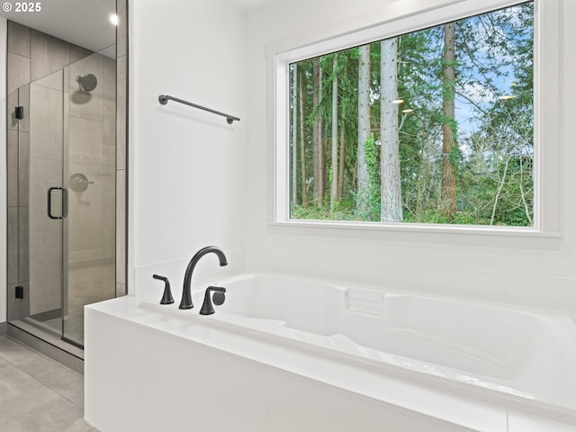 full bath featuring a shower stall, a garden tub, and a wealth of natural light