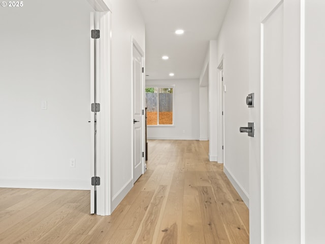 corridor with recessed lighting, baseboards, and light wood finished floors
