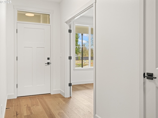 entryway featuring baseboards and light wood-style flooring