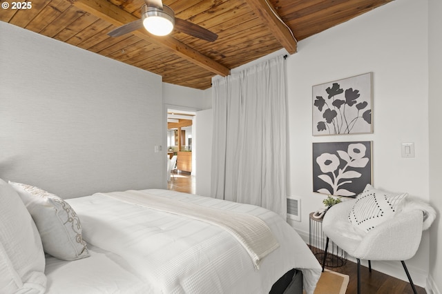 bedroom featuring visible vents, baseboards, beamed ceiling, wood ceiling, and wood finished floors