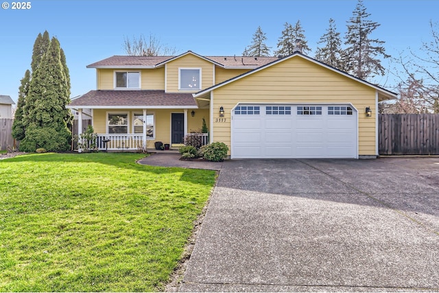 traditional-style house featuring concrete driveway, covered porch, an attached garage, fence, and a front lawn