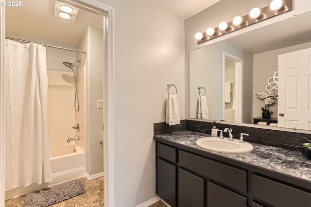 full bath with shower / tub combo, vanity, and baseboards