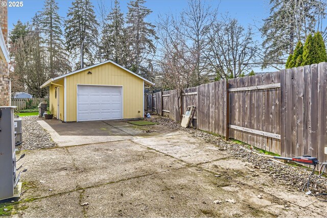 detached garage with driveway and fence