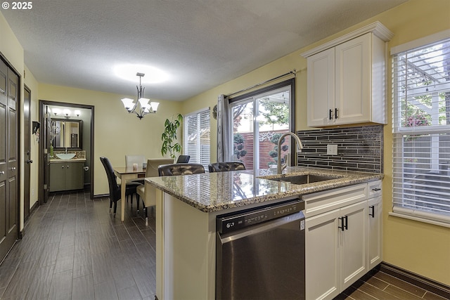 4422 SW Appletree Pl, Beaverton, OR 97078 - kitchen with stainless steel dishwasher, plenty of natural light, white cabinets, dark wood-style flooring, and a textured ceiling