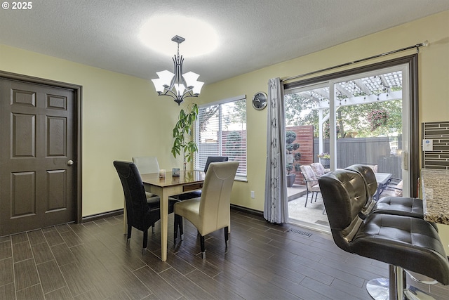 4422 SW Appletree Pl, Beaverton, OR 97078 - dining area with a chandelier, dark wood finished floors, and a textured ceiling
