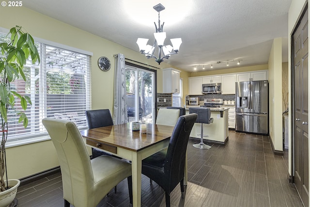 4422 SW Appletree Pl, Beaverton, OR 97078 - dining room featuring a chandelier and dark wood-style flooring
