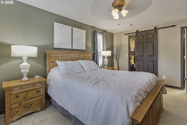 4422 SW Appletree Pl, Beaverton, OR 97078 - bedroom featuring light colored carpet, a barn door, and ceiling fan