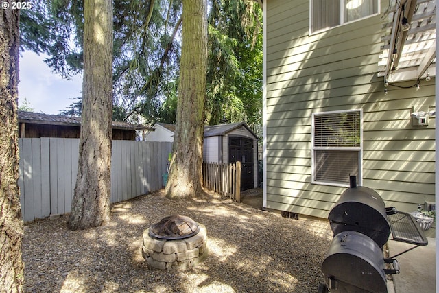 4422 SW Appletree Pl, Beaverton, OR 97078 - view of yard featuring a fire pit and a storage unit