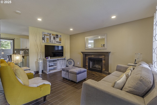 4422 SW Appletree Pl, Beaverton, OR 97078 - living area with a stone fireplace, recessed lighting, and dark wood-style flooring