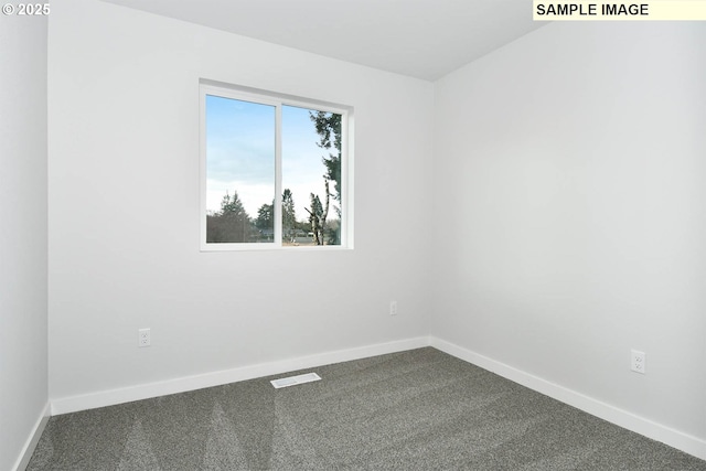 empty room with visible vents, baseboards, and dark colored carpet