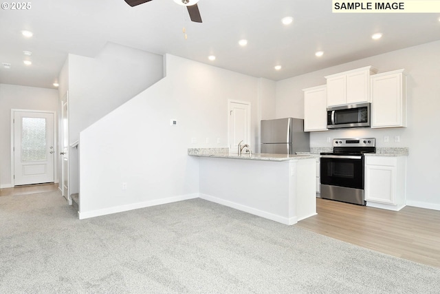 kitchen featuring a ceiling fan, recessed lighting, appliances with stainless steel finishes, white cabinets, and baseboards