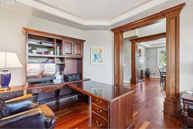 office space with decorative columns, a raised ceiling, and dark wood-type flooring
