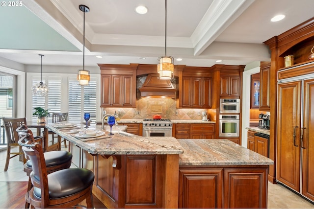 kitchen featuring custom exhaust hood, recessed lighting, high quality appliances, and a healthy amount of sunlight
