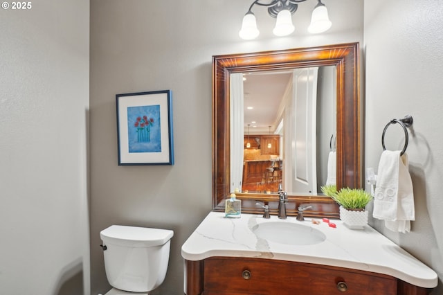 half bathroom featuring toilet and vanity